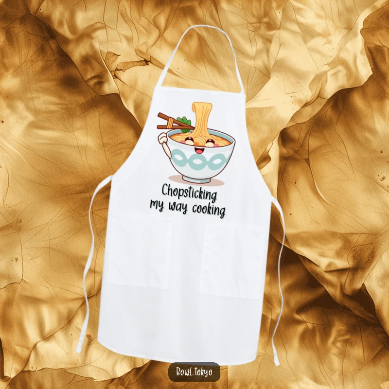 Funny Kitchen Ramen Bowl Apron with a smiling noodle character offering a chopstick, making cooking a friendly experience.