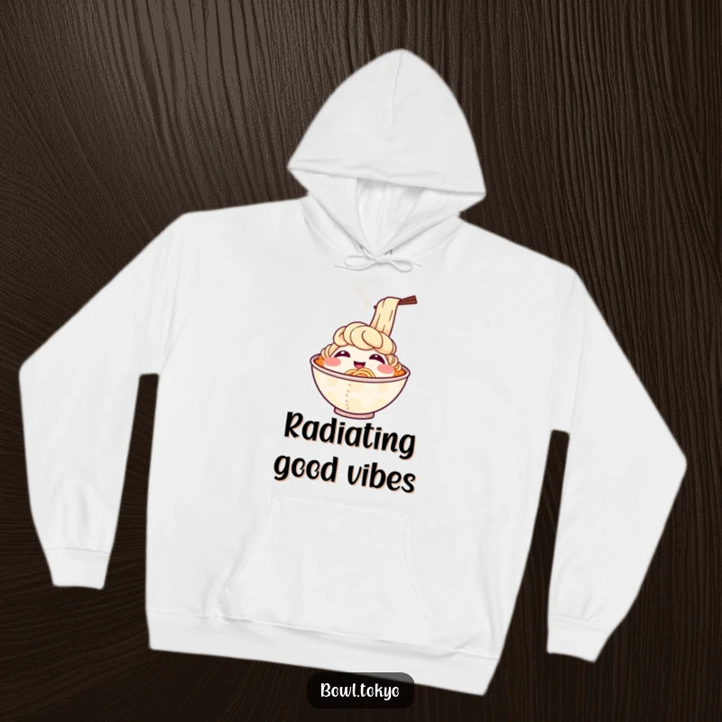 Funny, warm hoodie featuring a smiling ramen bowl character with steam rising as if it’s chuckling, offering cozy vibes.