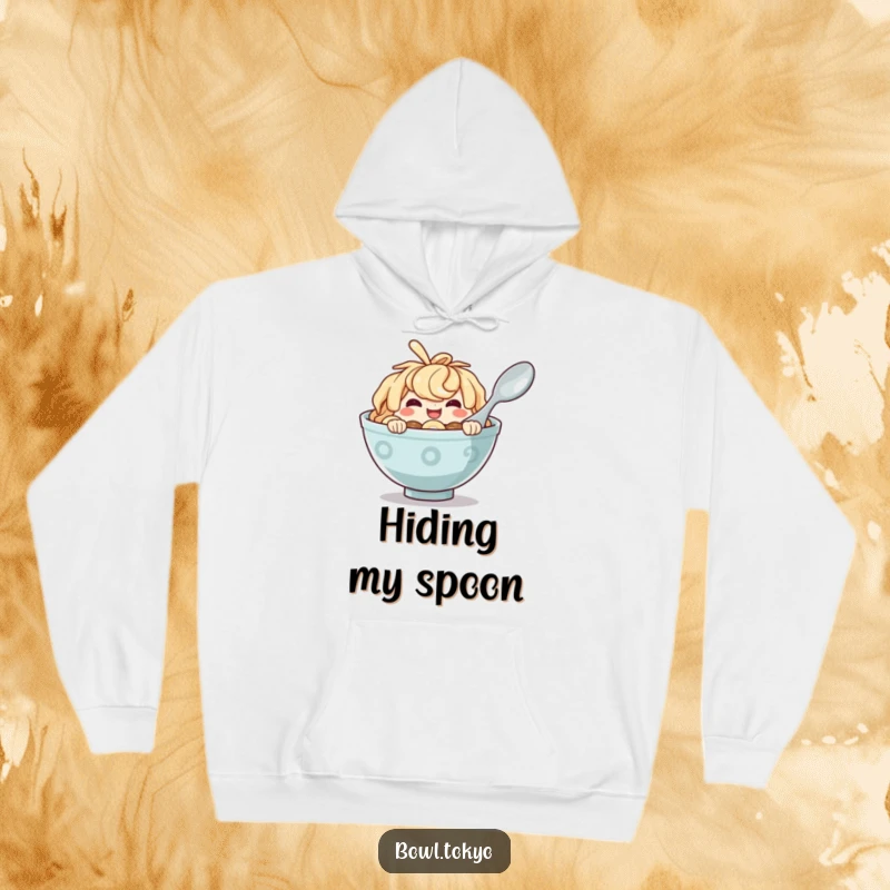 Funny Ramen Bowl Hoodie with a mischievous character peeking from behind a spoon, perfect for cozy, fun days.