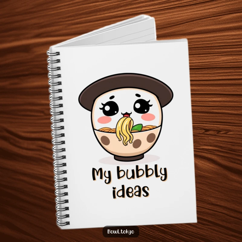 Funny notebook depicting a ramen bowl character with a silly expression, blowing a noodle bubble, great for jotting ideas.