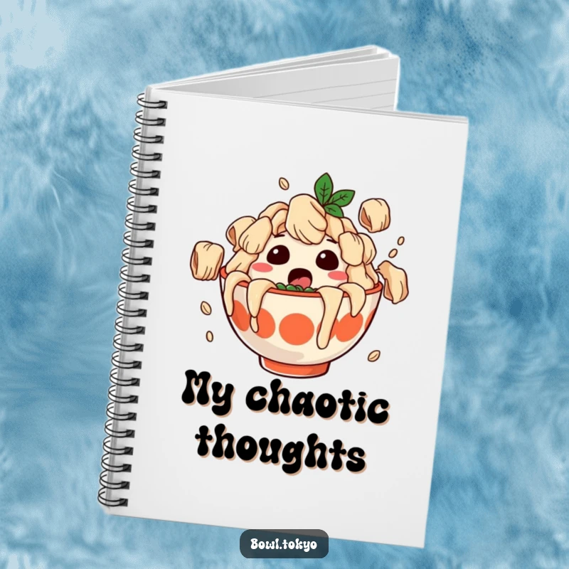 Funny notebook with a surprised ramen bowl character covered in falling dumplings, perfect for jotting down notes with a humorous twist.