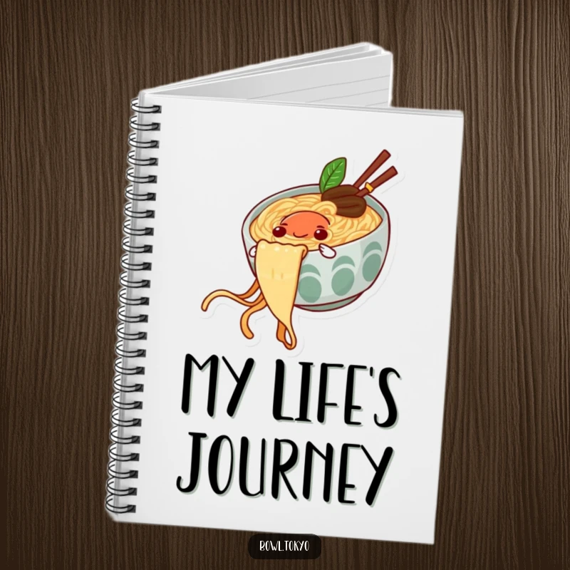 Funny notebook with a happy ramen bowl character sliding down a noodle string, ideal for jotting ideas.