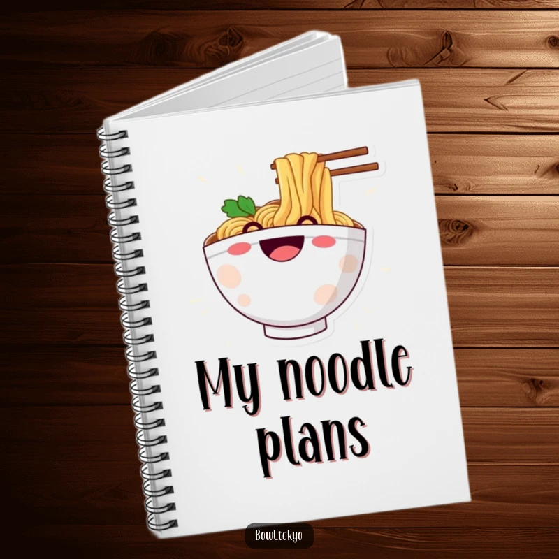 Funny notebook depicting a happy ramen bowl character grinning while sliding down a noodle, great for creative thoughts.