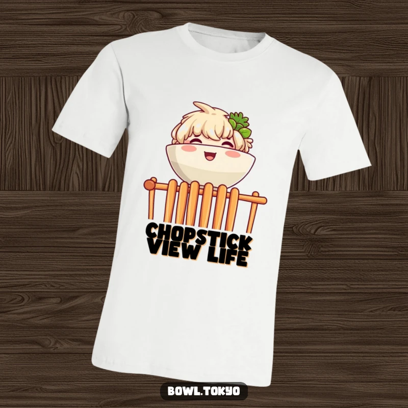 Funny t-shirt depicting a joyful ramen bowl character peeking over a barrier of chopsticks with a happy expression.