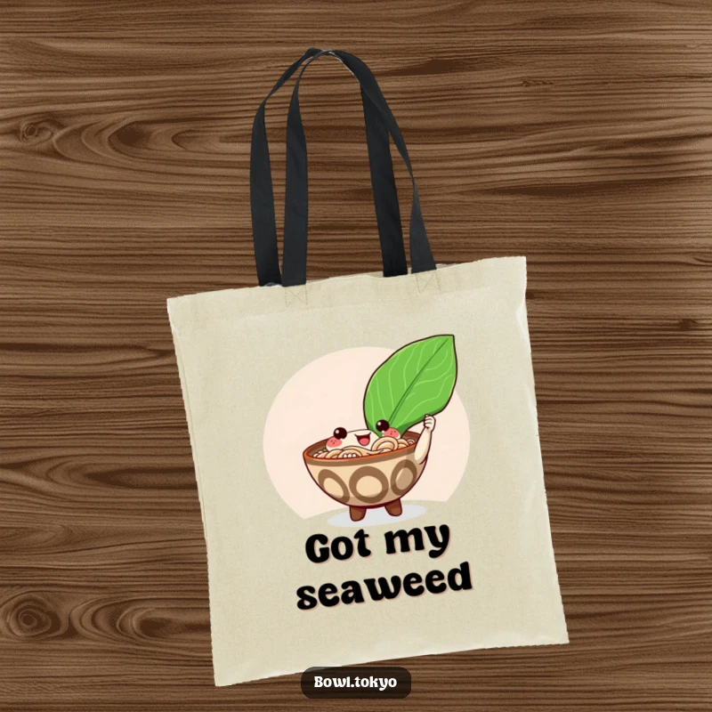 Funny happy ramen bowl tote bag character offering a giant shiny nori seaweed leaf, a stylish and humorous carry-all.